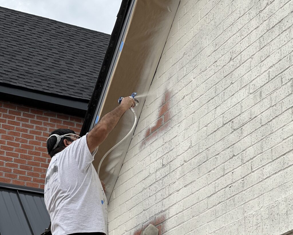 professional painter painting exterior brick